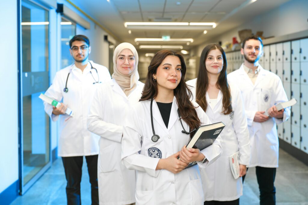 Doctors from different specialties standing and smiling, ready for your service