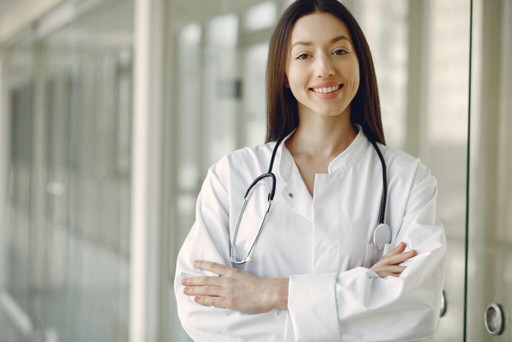 A smiling young doctor standing and ready to guide you